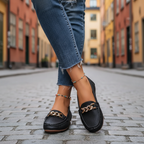 Black loafers - legs crossed