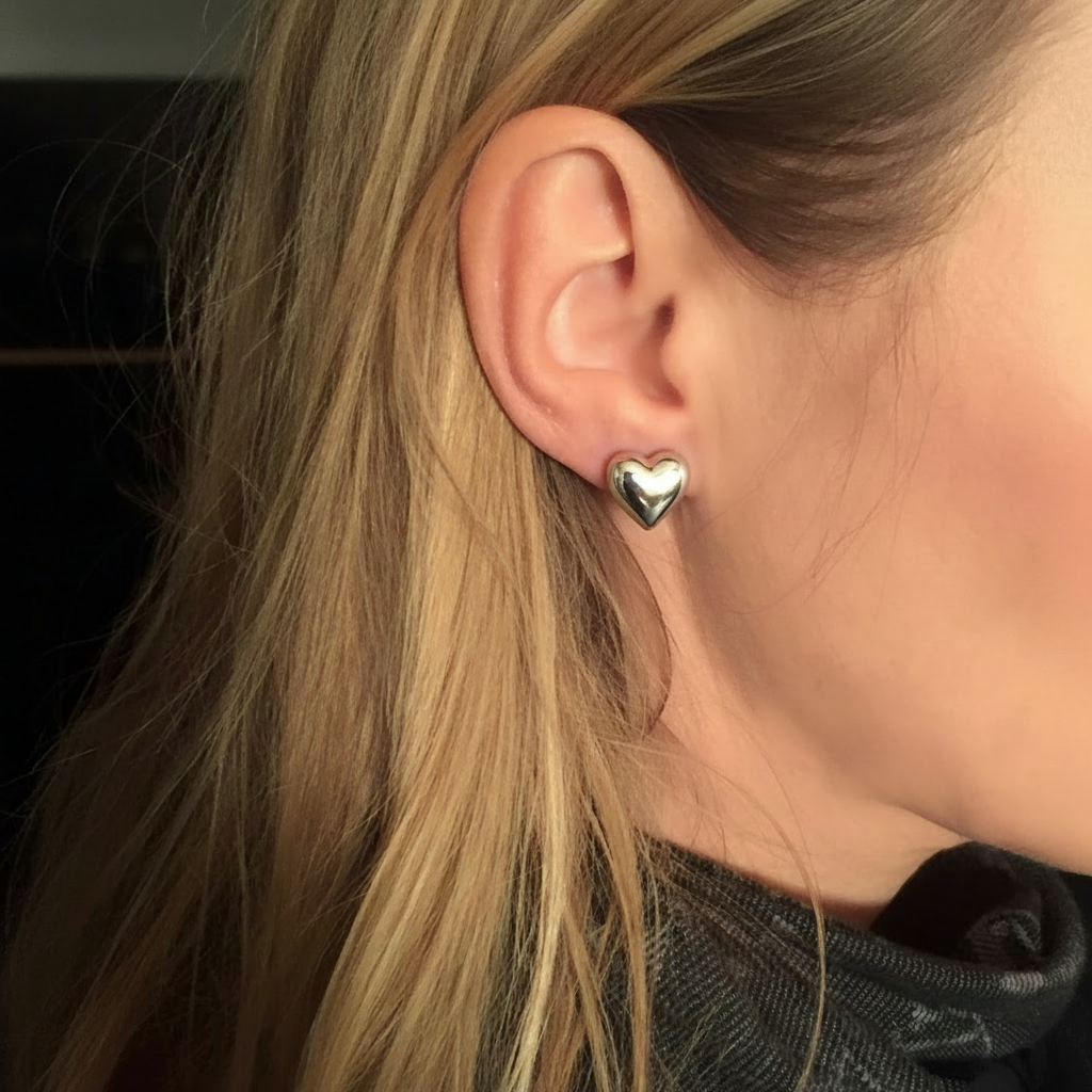 Blonde model wearing silver heart earrings