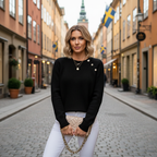 Blonde woman in black knit sweater with heart button in Stockholm