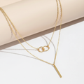Layered gold necklace flat lay