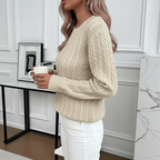 Side view of beige cable knit sweater