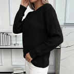 Side view of black cable knit sweater