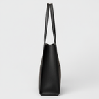 Side view of black leather tote bag
