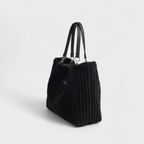 Side view of black quilted tote bag