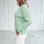 Side view of mint green cable knit sweater