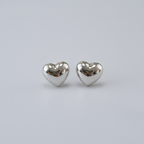 Silver heart earrings with plain background