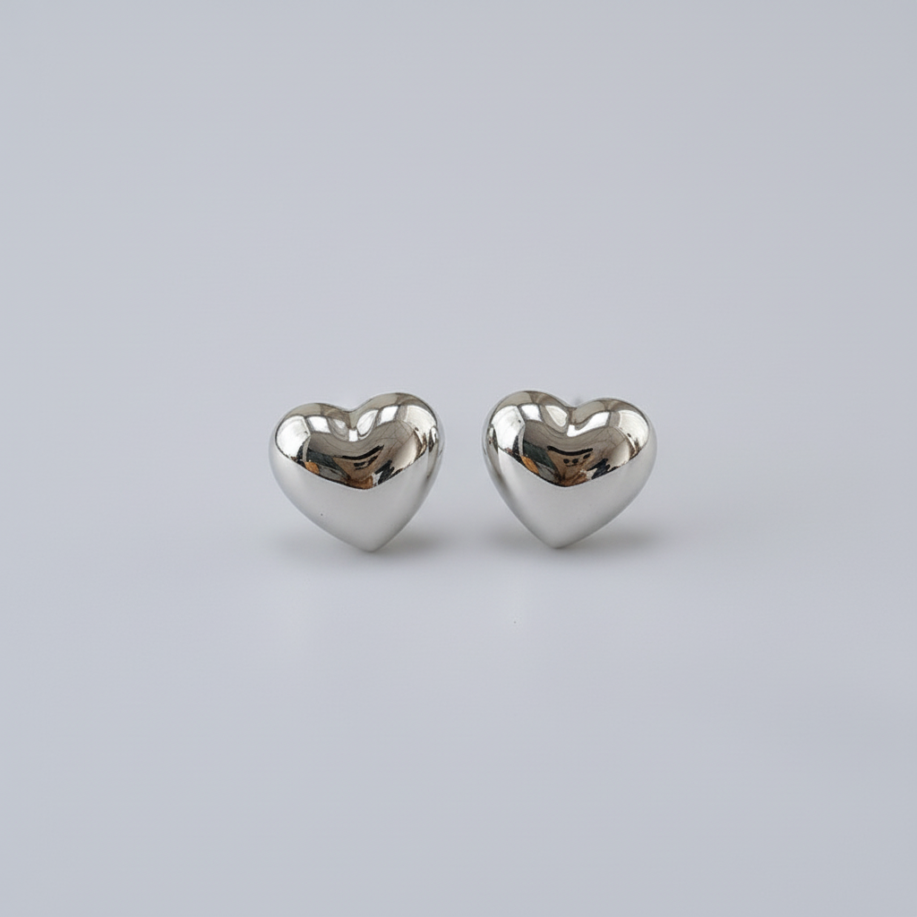 Silver heart earrings with plain background